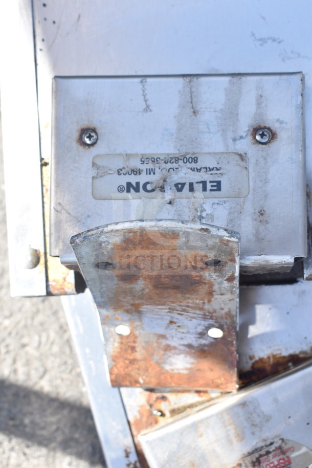 Three Elation swinging kitchen/traffic doors with visible wear, rust, and manufacturer label. Bid offers for all three.