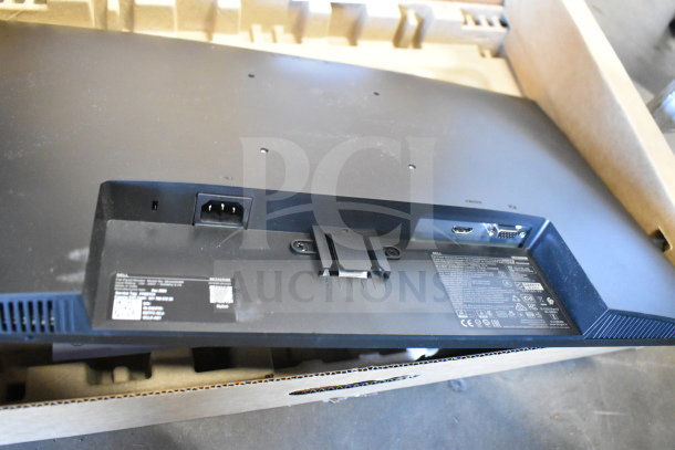 Two Dell computer monitors, models SE2425HMf and E1715S, shown with ports and labels, in a cardboard box.