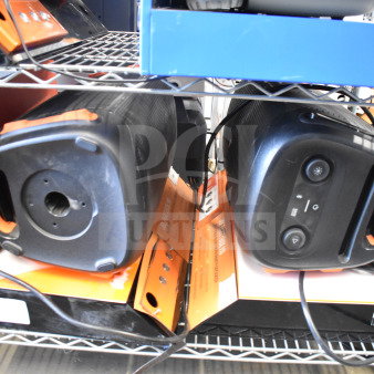 Two JBL PartyBox portable Bluetooth speakers on a shelf, showcasing front controls and brand packaging. Condition appears good.