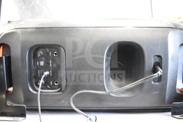Two JBL PartyBox portable Bluetooth speakers with input panel and ports visible. Power and AUX-in cables connected.