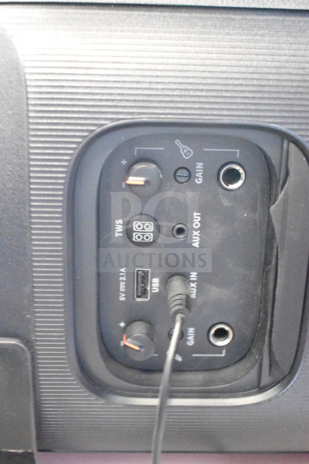 Rear panel of JBL PartyBox Portable Bluetooth Speaker showing controls and ports, including AUX, USB, and gain knobs.