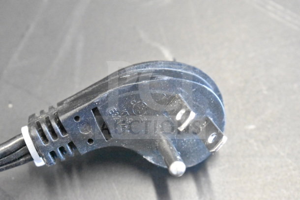 Close-up of a black electrical plug with visible text indicating specifications.