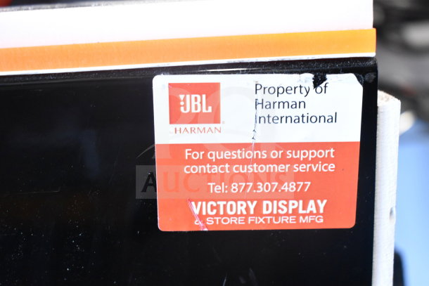 JBL PartyBox portable Bluetooth speaker with a label indicating ownership by Harman International.