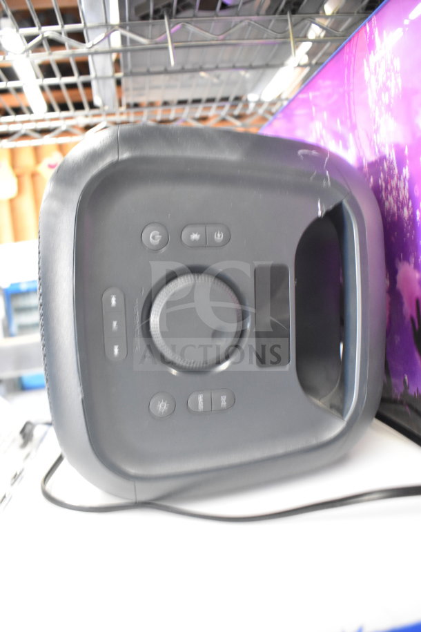 Onn portable Bluetooth speaker, black, with control buttons and carrying handle, in used condition.