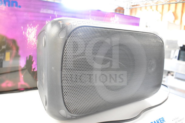 Onn Portable Bluetooth Speaker, black, textured front grill, used condition, box visible, enhances audio experience.