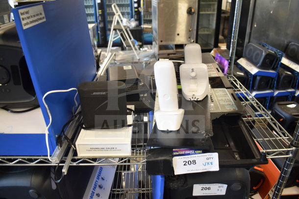 8-item set including Bose SoundLink Color II speaker and Netgear router, displayed on metal shelves. Condition appears used.