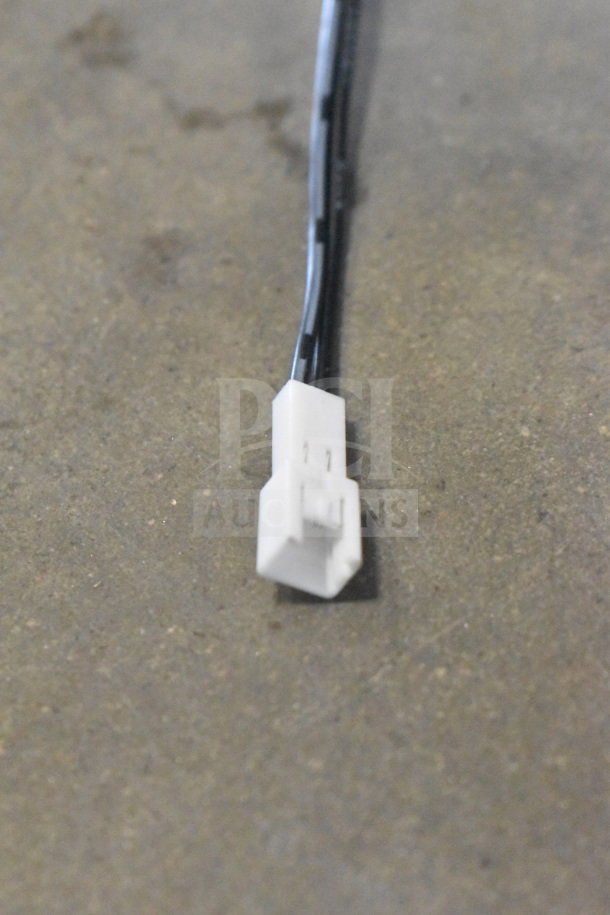 White electrical connector on a gray surface, part of an 8-item lot including a Bose speaker and Netgear router.