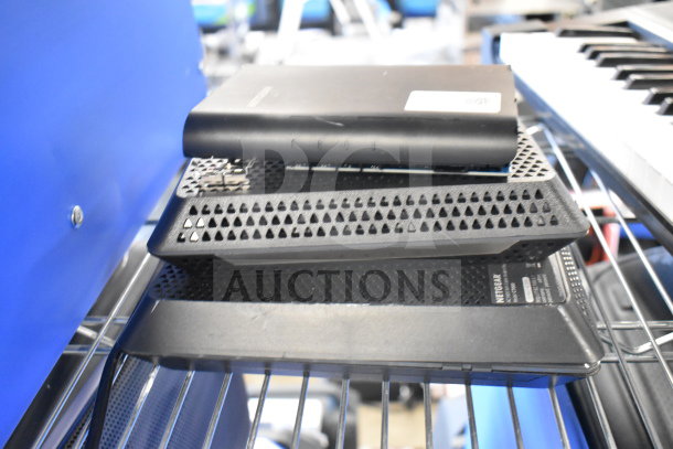 8 various electronics stacked, featuring a Bose speaker and Netgear router, black, in used condition. Labels visible.