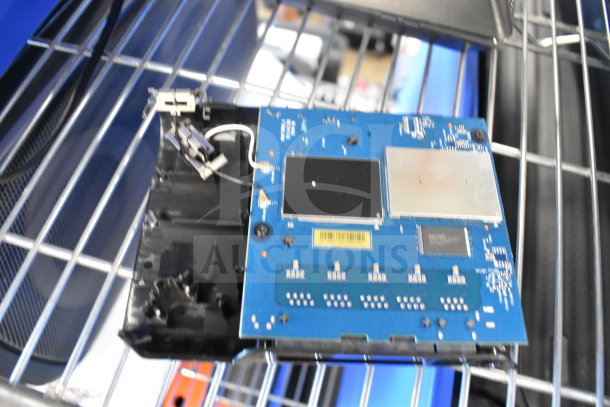 Circuit board on a metal shelf, part of 8-item auction lot, includes Bose speaker and Netgear router.