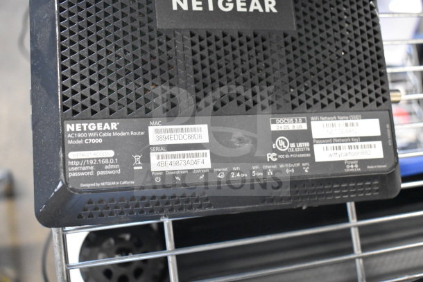 Netgear AC1900 WiFi Cable Modem Router C7000, showing labels with MAC and Serial numbers.