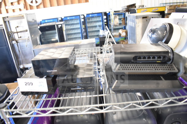 6 various items including Netgear Nighthawk router on metal shelf; routers include multiple Ethernet ports. Auction lot 209.