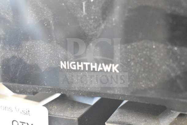Nighthawk Netgear router with visible label, showing minor wear. Part of a lot of six various items.