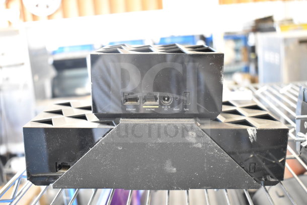 Netgear Nighthawk router, black, with Ethernet and Internet ports, reset and sync buttons, pre-owned condition.