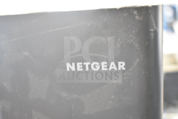 Netgear router featuring Nighthawk model branding; surface exhibits slight wear, enhancing functional value for networking.