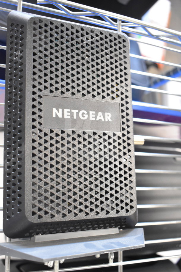 Netgear router with black perforated design, featuring a visible logo. Part of a 6-item auction package.