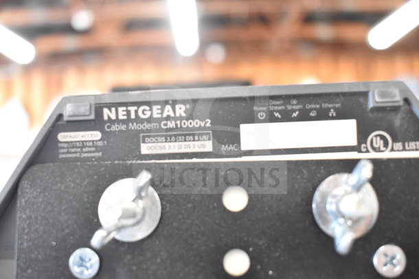 Netgear Cable Modem CM1000v2, DOCSIS 3.0/3.1, default access info visible, features and certifications displayed.