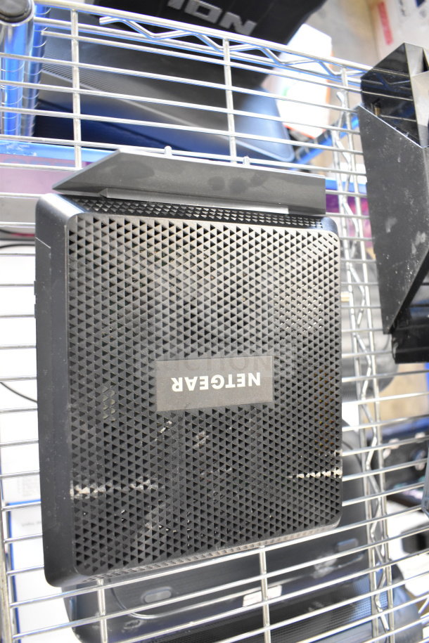 Netgear Nighthawk router, black finish, mesh ventilation design, minor surface wear, labeled "NETGEAR" on top.