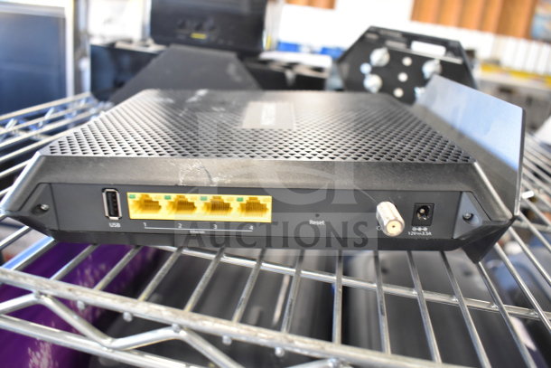 Netgear Nighthawk router with USB, Ethernet ports; good condition, slight surface marks. Part of 6-item auction lot.