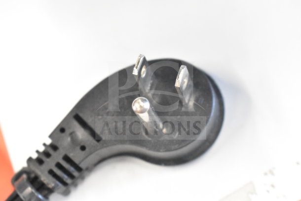 Close-up of a black power plug with three prongs on a white background, unrelated to the JBL Boombox 3 speaker listing.