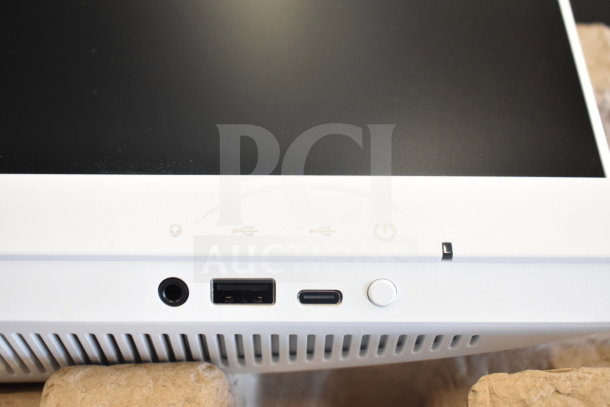 Acer C24B Series PC bottom view, showing ports including USB, USB-C, audio jack, and power button in excellent condition.