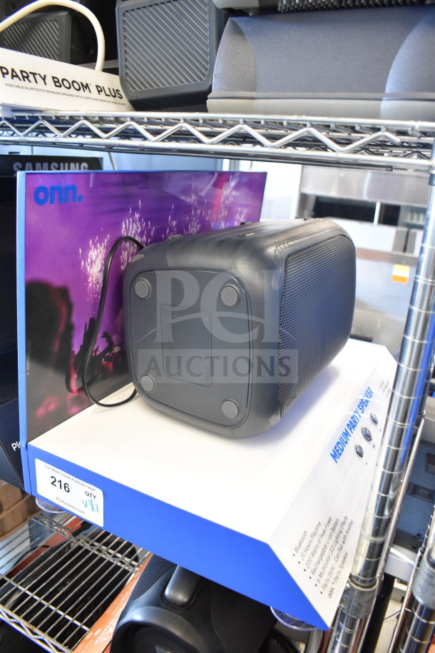 Samsung and Onn medium party speakers on shelf; both in good condition, offering portable Bluetooth audio.