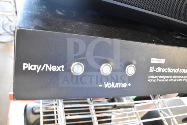 Samsung speaker control panel with Play/Next and Volume buttons, featuring bi-directional sound capability.