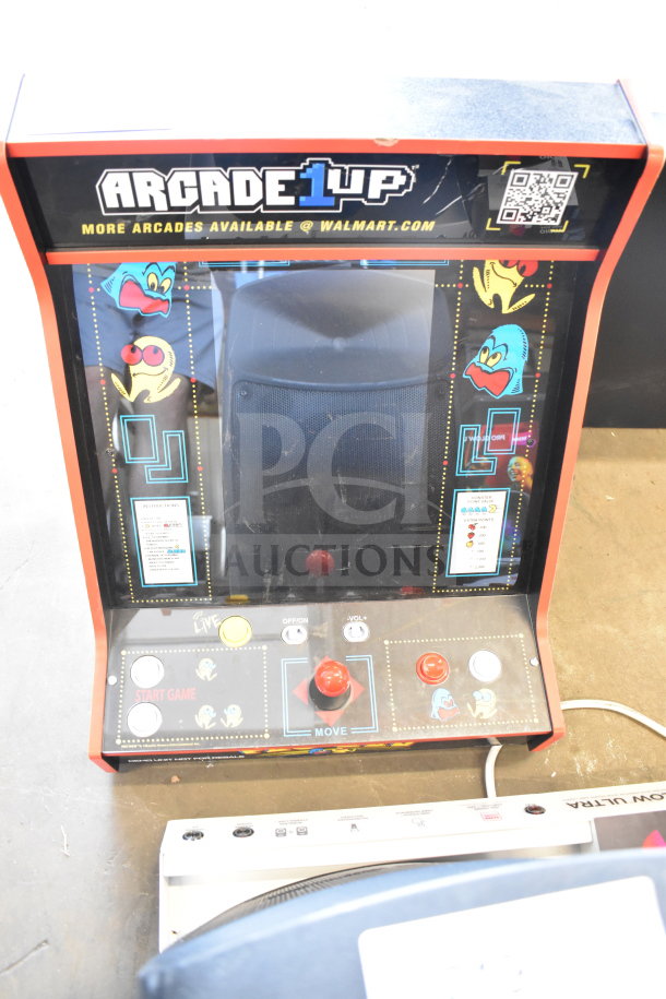 Arcade 1UP Pac-Man Machine, Model PAC-A-501030, features classic game art, joystick controls, in good condition.