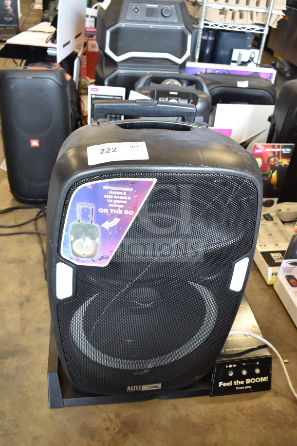 Altec Lansing IMT7002 speaker with retractable handle. Black, excellent condition, features wheeled mobility.