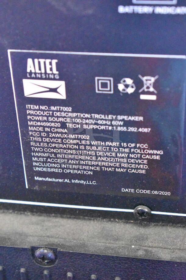 Altec Lansing IMT7002 Speaker label showing model, power source, FCC compliance, and date code 08/2020. Made in China.