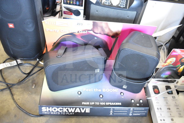 Store display with two Altec Lansing speakers, labeled "Shockwave." Features Bluetooth connectivity and multi-speaker pairing.