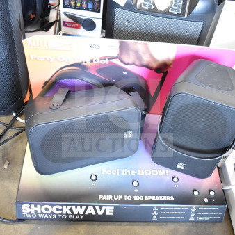 Store display with two Altec Lansing speakers, labeled "Shockwave." Features Bluetooth connectivity and multi-speaker pairing.