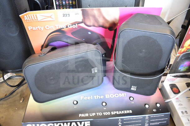 Altec Lansing store display with two black speakers, labeled "Party On The Go!" in good condition.