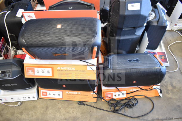 JBL Partybox 110 speakers on display, in good condition. Features include Bluetooth, mic inputs, and dynamic light show.