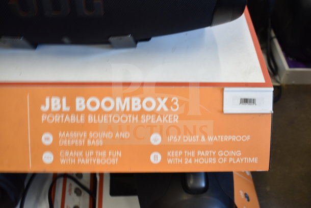 JBL Boombox 3 Speaker display showing key features: massive sound, IP67 waterproof, PartyBoost, 24-hour playtime.