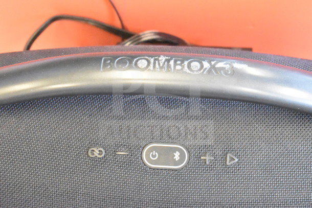 JBL Boombox 3 speaker, store display model, black with control buttons visible. "BOOMBOX3" marking on handle.