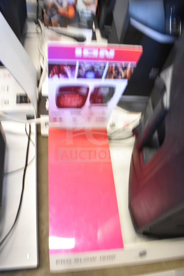 Blurry image of store display featuring Ion Pro Glow 1500 speaker, with promotional graphics and speaker unit visible.