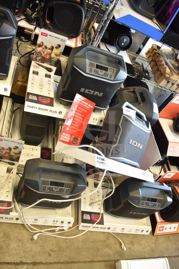 Six Ion Party Boom Plus speakers on display. Features include wide-range sound, control panel. New condition, with packaging.