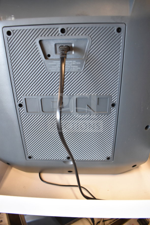 Ion Party Boom Plus speaker back panel with power cord plugged in. Brand name “ION” embossed on panel.