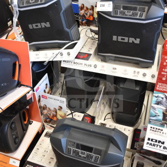 Ion Party Boom Plus speaker, store display, includes six units. Features wide-range sound, Bluetooth, and microphone input.