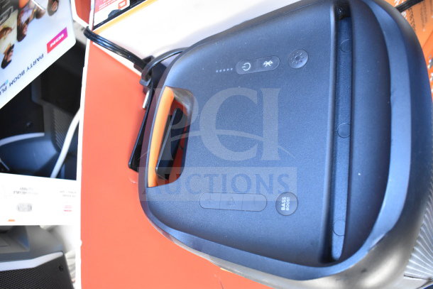JBL Partybox 110 Bluetooth speaker on store display, shown with handle. Features controls for power, Bluetooth, and bass boost.