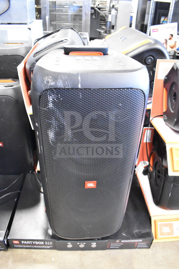 JBL Partybox 310 Speaker for auction. Slightly used; visible scuffs. Includes original packaging and store display.