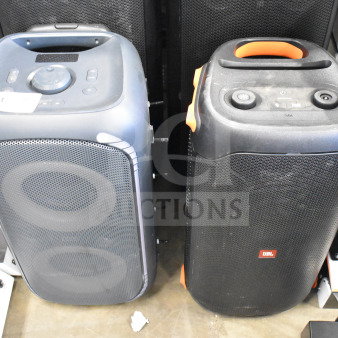 Two JBL speakers shown side-by-side, featuring control panels and carrying handles, in gently used condition.