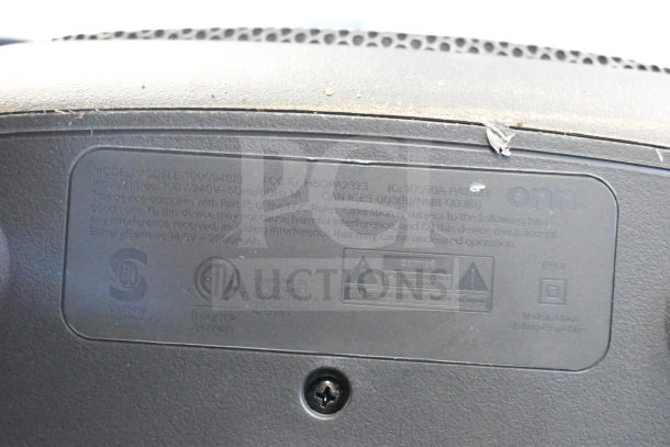 Label on ONN speaker, model 100094813, showing input of 100V-240V, 50Hz/60Hz 1A, and battery 14.9V 2500mAh.