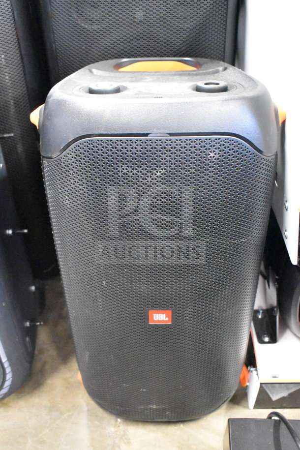 JBL speaker in black, featuring mesh grille and orange accents. Visible JBL logo; excellent condition. Auction includes two items.