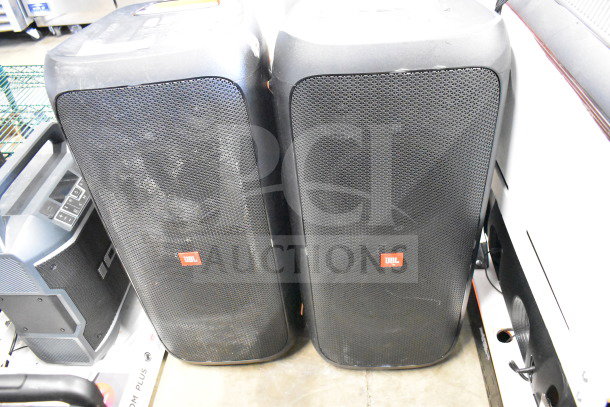 Two JBL Partybox 310 speakers. Black with visible JBL logo. Excellent condition for high-quality audio.