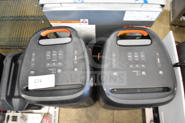 2 JBL Partybox 310 speakers, black, top view showing controls. Slight wear visible. Auction tag 234 attached.
