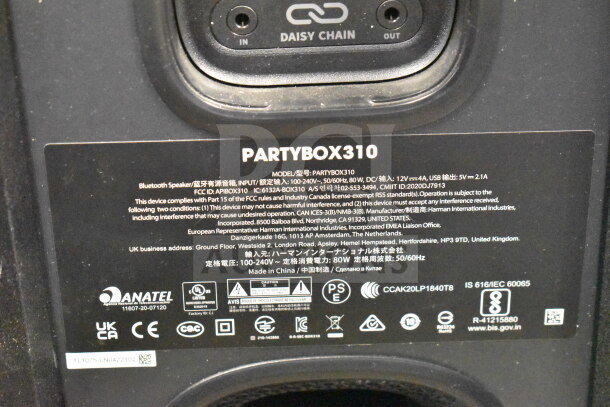 Close-up of JBL Partybox 310 speaker back panel with model details, connectivity options, and compliance labels visible.