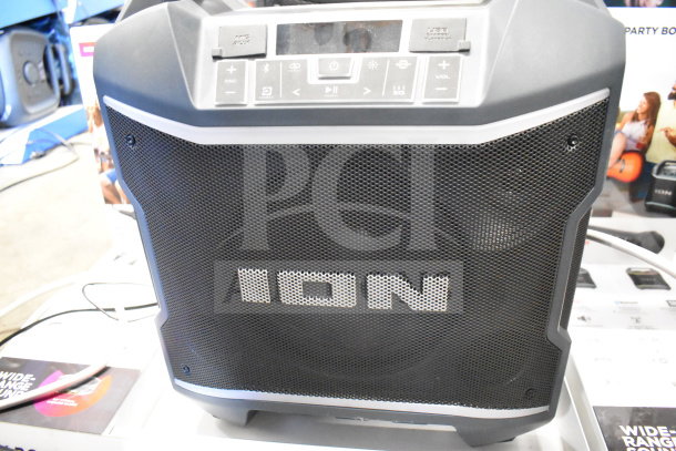 Ion Party Boom Plus speaker with control panel and branding. Features mic input, USB, and volume controls. Store display model.