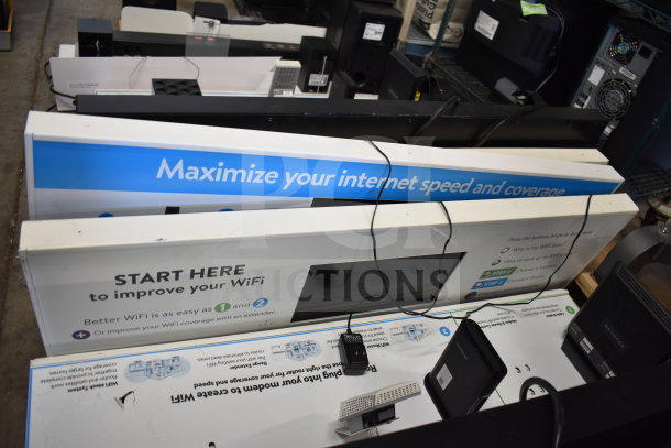 5 store display units with signage promoting WiFi speed enhancement. Includes black routers and cables. Condition appears good.