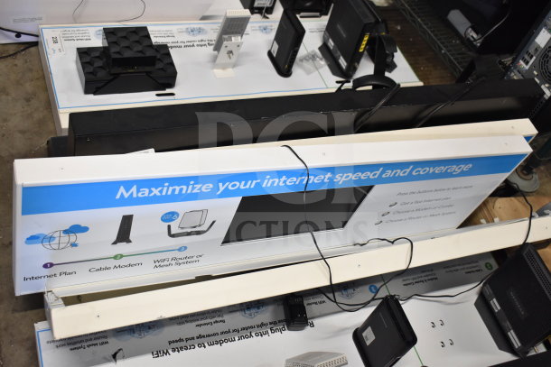 Store display featuring internet plan info, cable modem, WiFi router/mesh system. Sign reads "Maximize your internet speed and coverage."